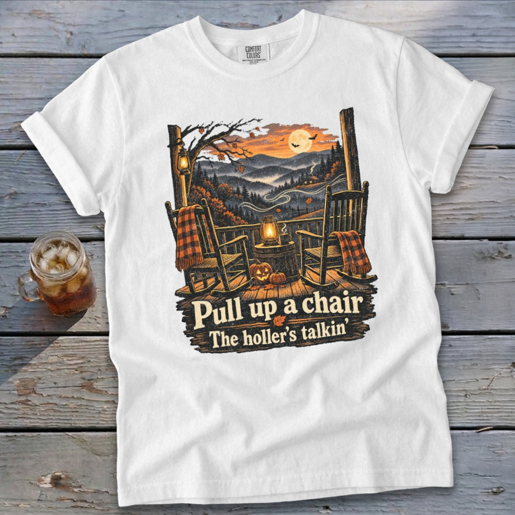 White t-shirt with rocking chairs, pumpkins, and "Pull up a chair, The holler's talkin'" text.