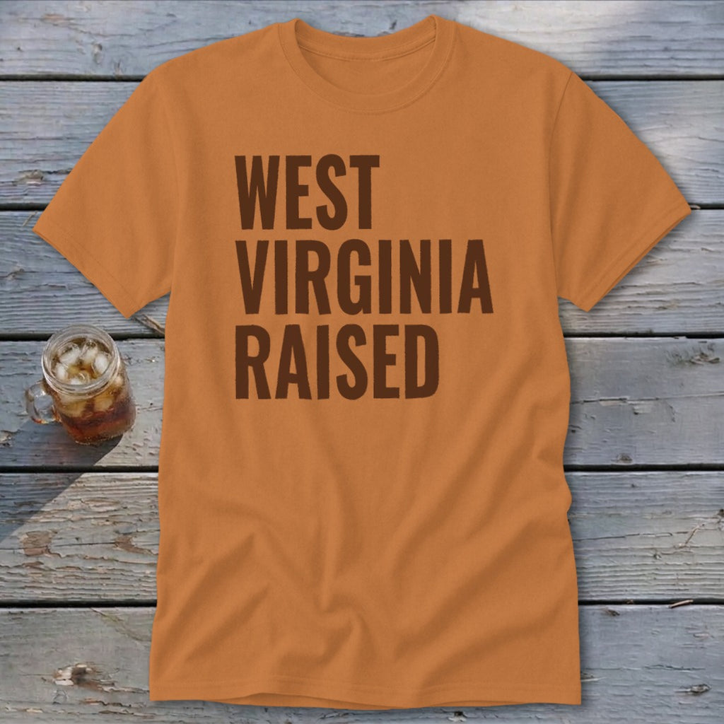 Orange t-shirt with brown text "WEST VIRGINIA RAISED".
