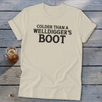 Cream t-shirt with black text reading "COLDER THAN A WELLDIGGER'S BOOT".