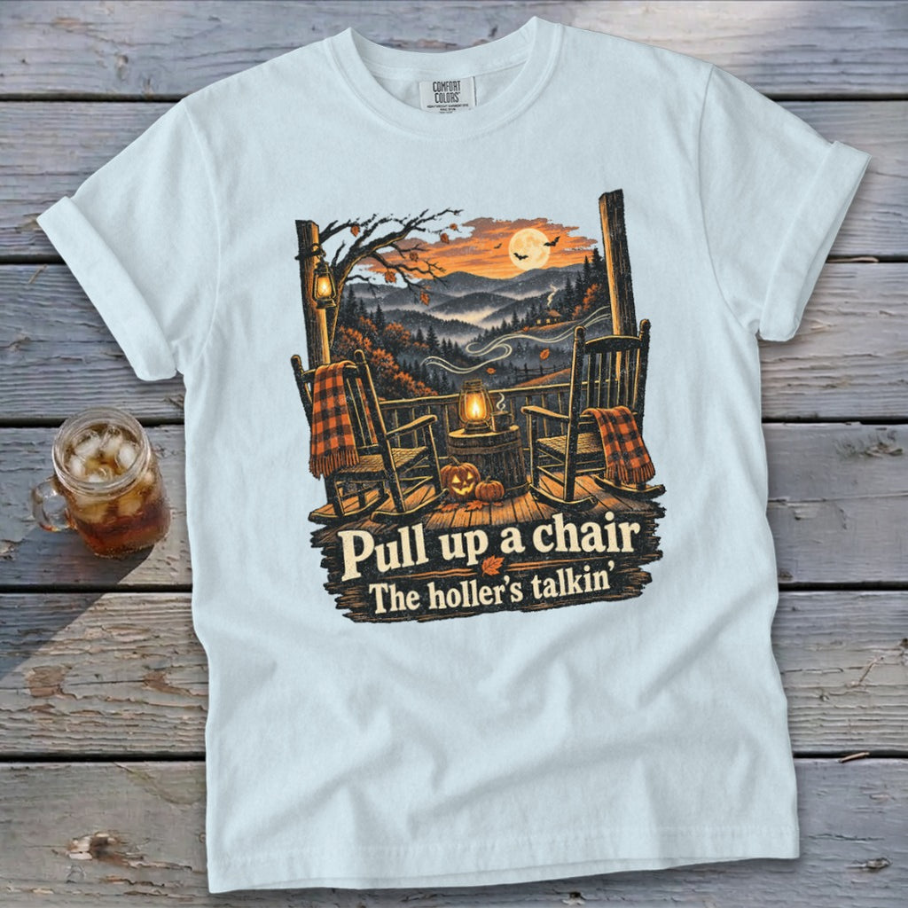 T-shirt with rocking chairs, lanterns, pumpkins, and text "Pull up a chair, The holler's talkin'".