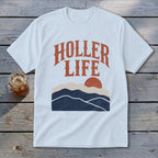 Light blue t-shirt featuring the text Holler Life above a graphic of mountains and a setting sun.