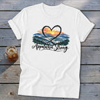 White t-shirt with a heart encircling a mountain sunset and the text "Appalachia Strong".
