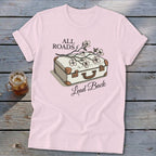 Light pink t-shirt with vintage suitcase graphic and text "ALL ROADS Lead Back".