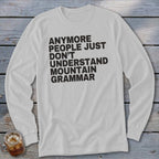White long-sleeve shirt with black text: "ANYMORE PEOPLE JUST DON'T UNDERSTAND MOUNTAIN GRAMMAR."