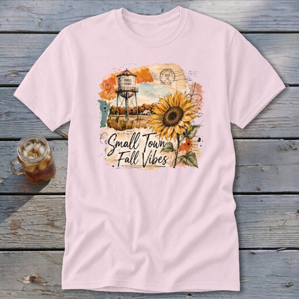 T-shirt with watercolor graphic of a water tower, sunflower, and text "Small Town Fall Vibes".