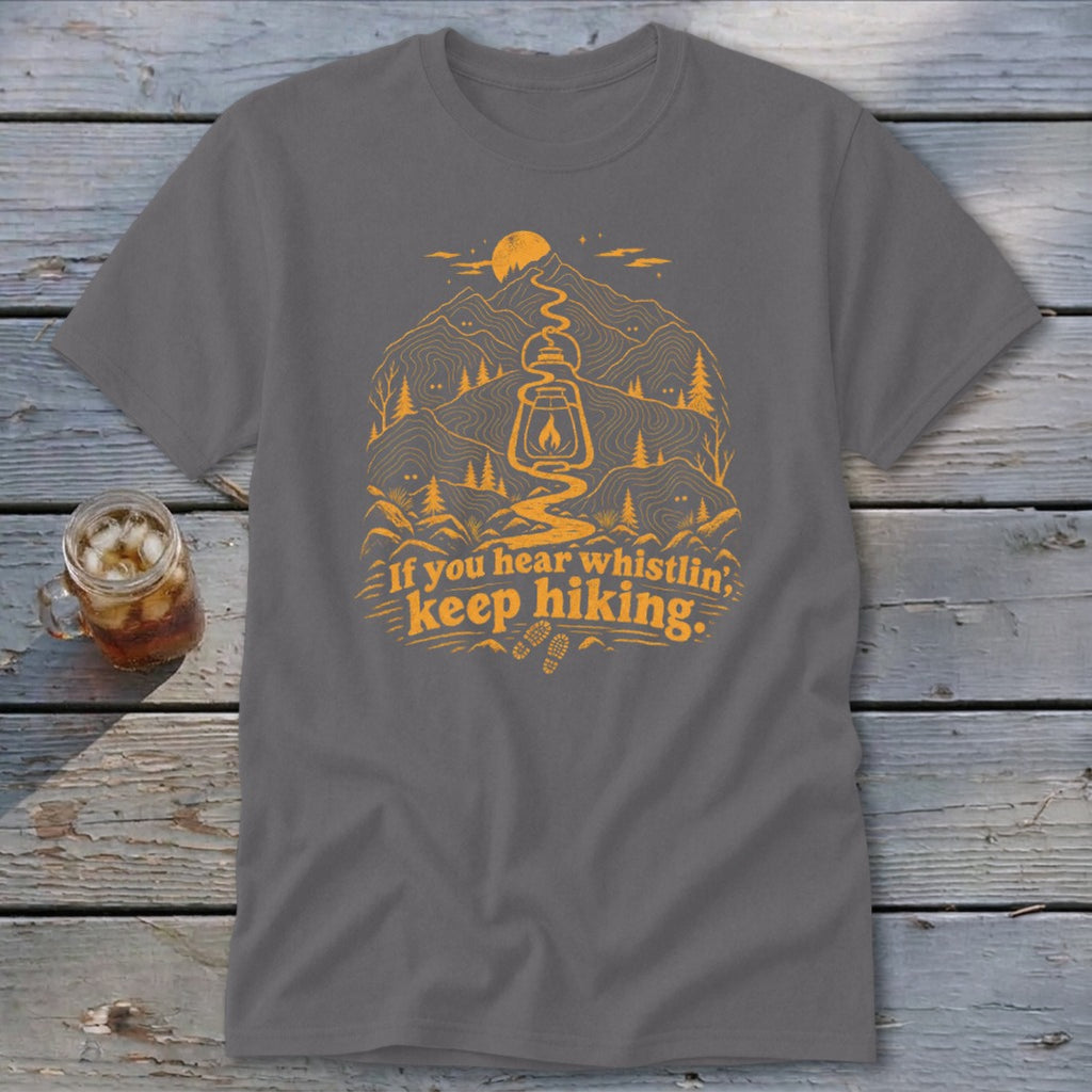 Grey t-shirt with orange mountain graphic and text "If you hear whistling, keep hiking."