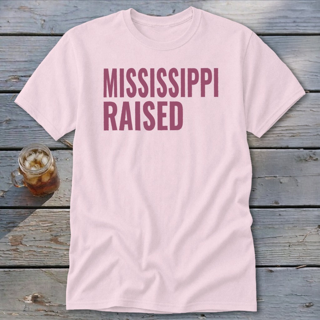 Light pink t-shirt with "MISSISSIPPI RAISED" text in maroon.