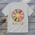 White t-shirt with a colorful Dresden Plate quilt design and text.