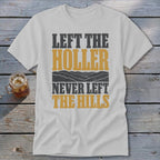 White t-shirt with text "LEFT THE HOLLER NEVER LEFT THE HILLS" and mountain graphic.