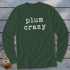 Long sleeve green shirt with white text "plum crazy"