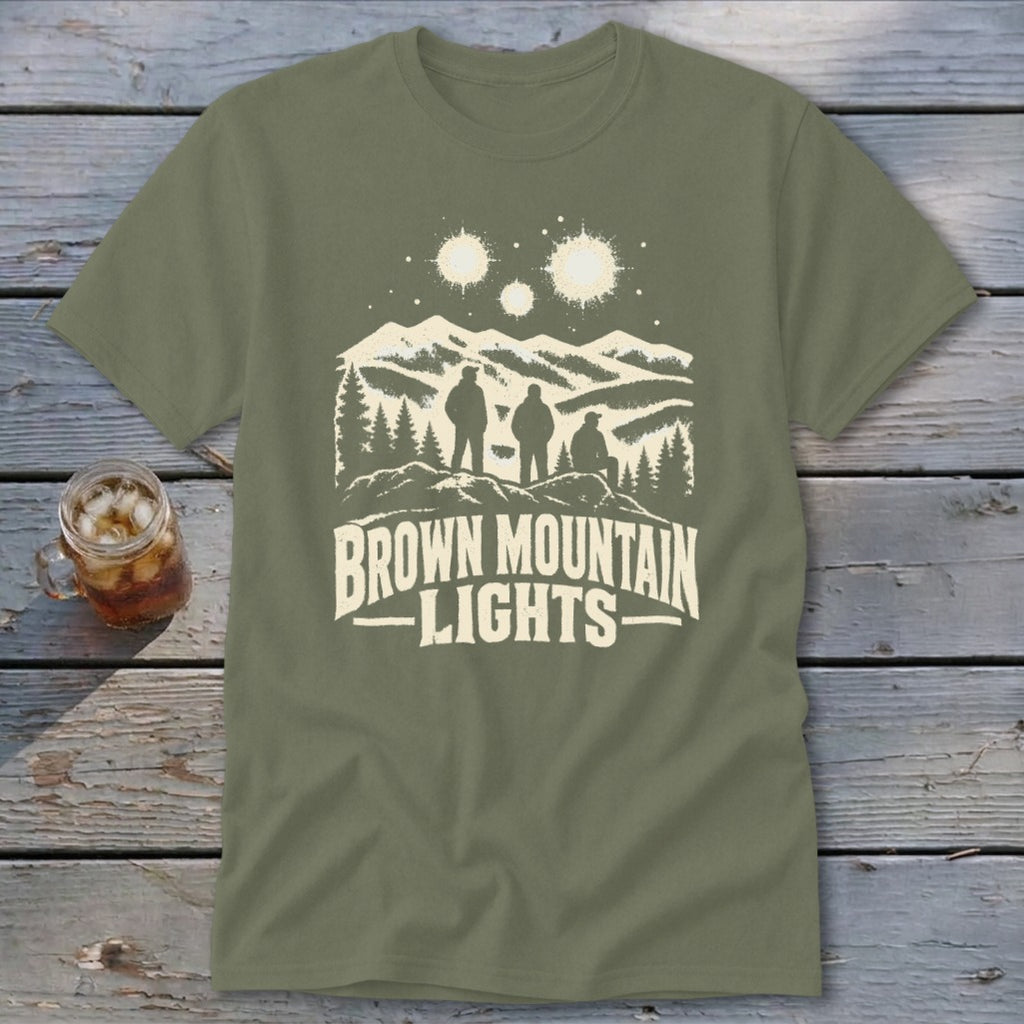 An olive green t-shirt featuring a mountain graphic with glowing lights and the text Brown Mountain Lights.
