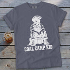 Grey t-shirt with white graphic of a boy in overalls and cap with a bucket, "COAL CAMP KID".