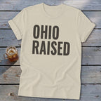 Cream t-shirt with "OHIO RAISED" printed in dark gray block letters.