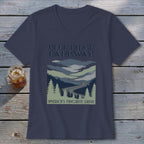 Dark blue V-neck t-shirt featuring a retro Blue Ridge Parkway mountain graphic and text on a wooden background.