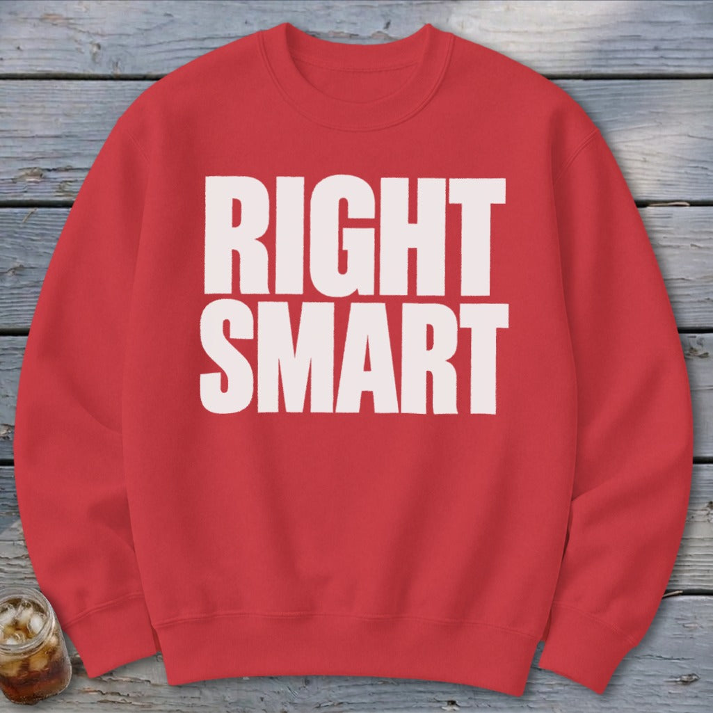 Red sweatshirt with white text "RIGHT SMART" on a wooden background.