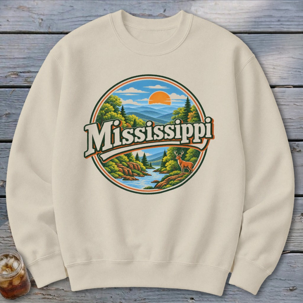 Cream sweatshirt with circular "Mississippi" graphic of mountains, river, and deer.