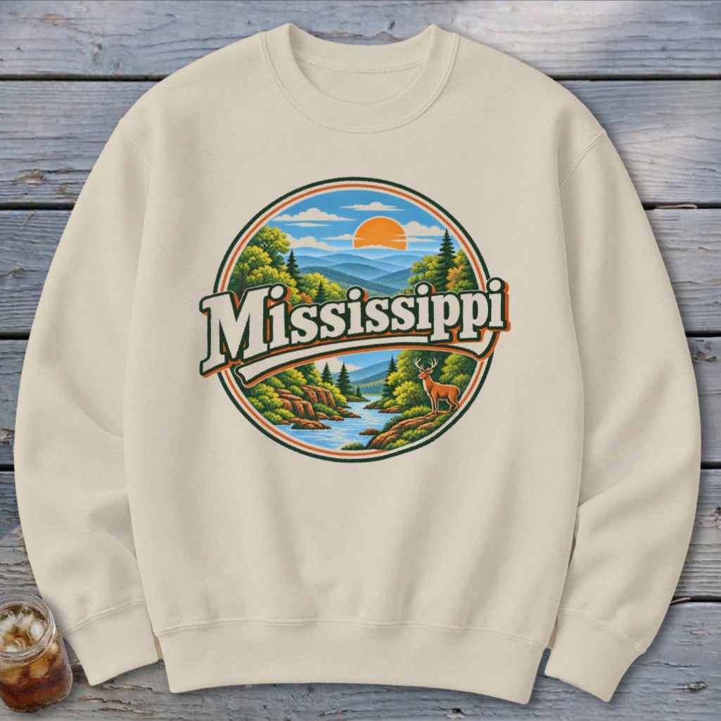 Cream sweatshirt with circular "Mississippi" graphic of mountains, river, and deer.