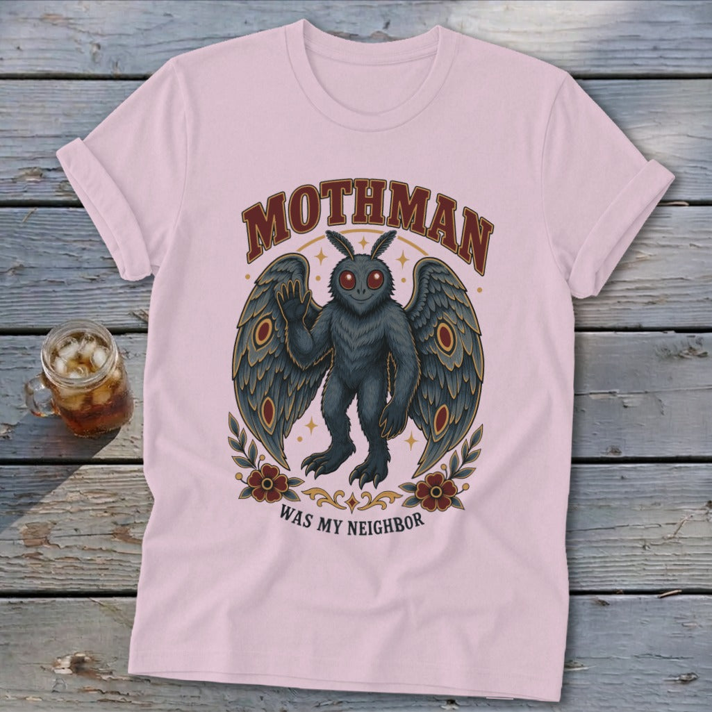 Pink t-shirt with Mothman graphic and text "Mothman Was My Neighbor".