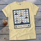 Yellow t-shirt with a blue and gray flying geese quilt design and text.