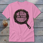 Pink t-shirt with a cast iron skillet graphic that reads "No Sugar in the Cornbread".