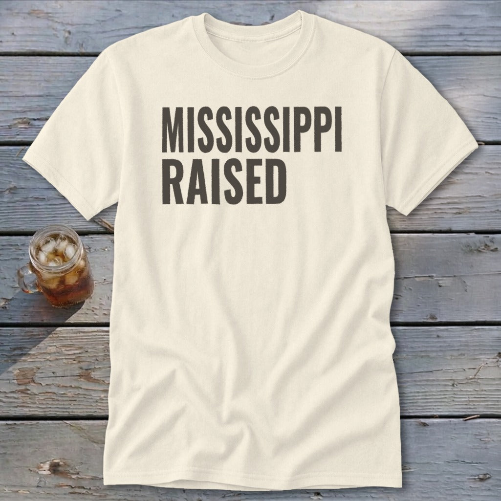 Cream t-shirt with "MISSISSIPPI RAISED" text in dark grey.
