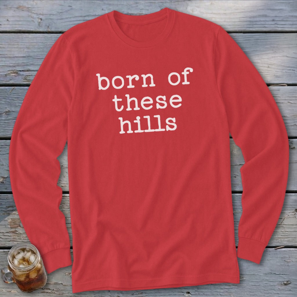 Red long sleeve shirt with "born of these hills" text in white.