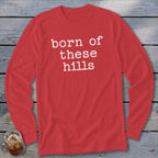 Red long sleeve shirt with "born of these hills" text in white.