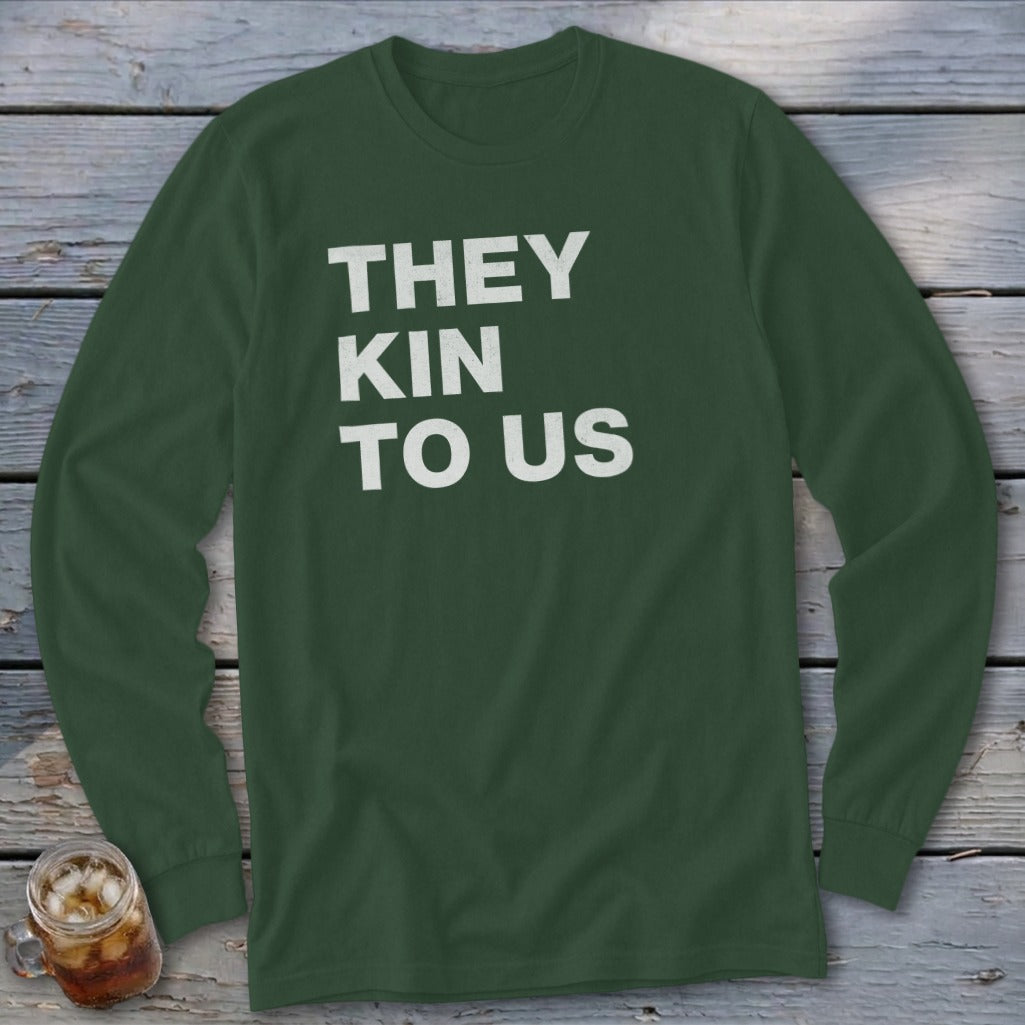Dark green long-sleeve shirt with white text reading "THEY KIN TO US".