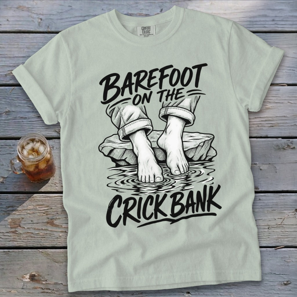 Light green t-shirt with "Barefoot on the Crick Bank" graphic.