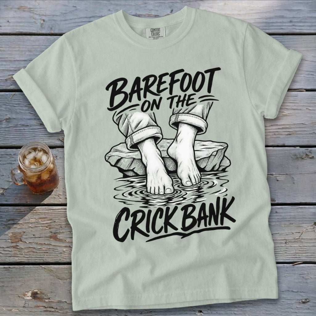 Light green t-shirt with "Barefoot on the Crick Bank" graphic.
