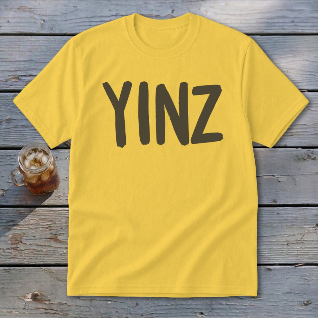 Yellow t-shirt with the word "YINZ" in dark brown letters.
