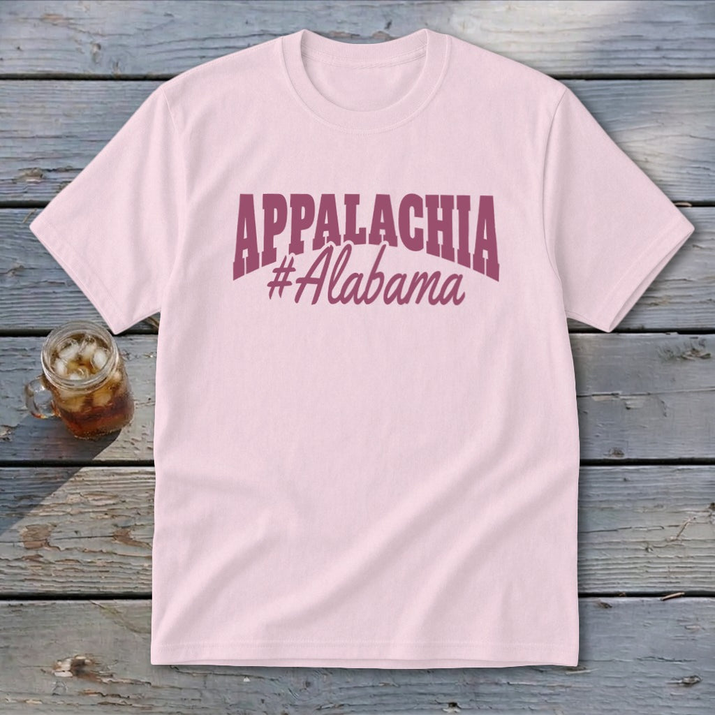 Pink t-shirt with "APPALACHIA #Alabama" text, beside a glass of iced tea.