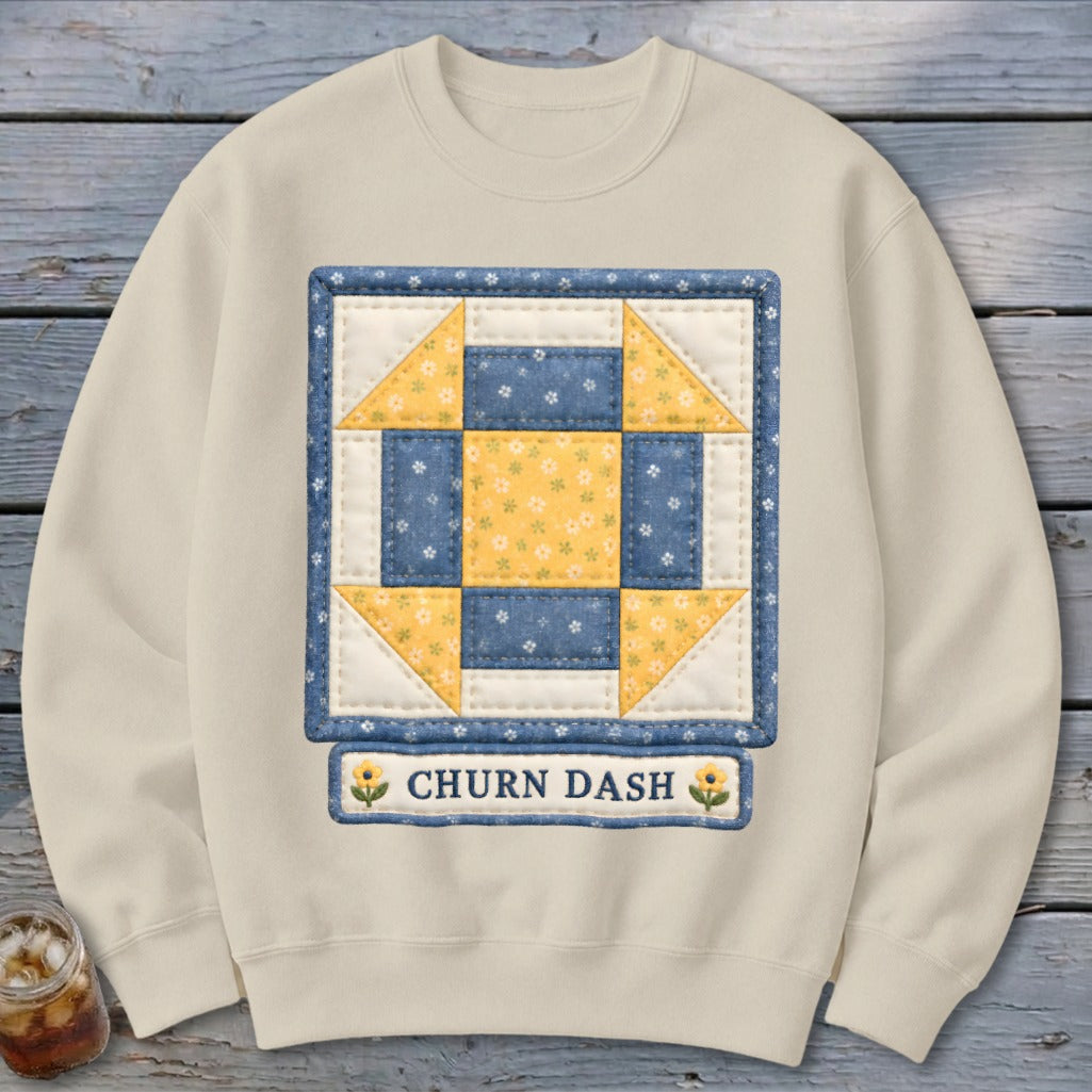 Cream sweatshirt with a square quilt block featuring blue and yellow floral patterns.