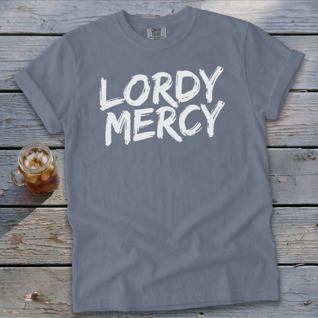 Gray t-shirt with white text reading "LORDY MERCY" and a glass of iced tea.