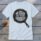 White t-shirt with cast iron skillet graphic that reads "No Sugar In The Cornbread".