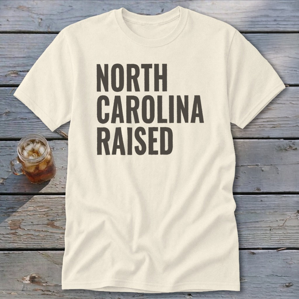 Cream t-shirt with black text that reads "NORTH CAROLINA RAISED".