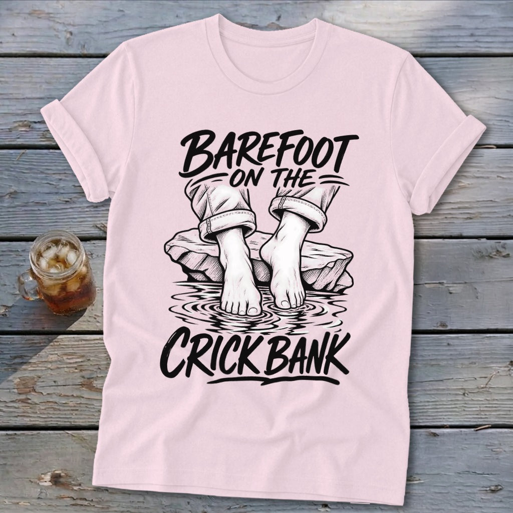 Pink t-shirt with graphic art of bare feet on rocks, "Barefoot on the Crick Bank" text.