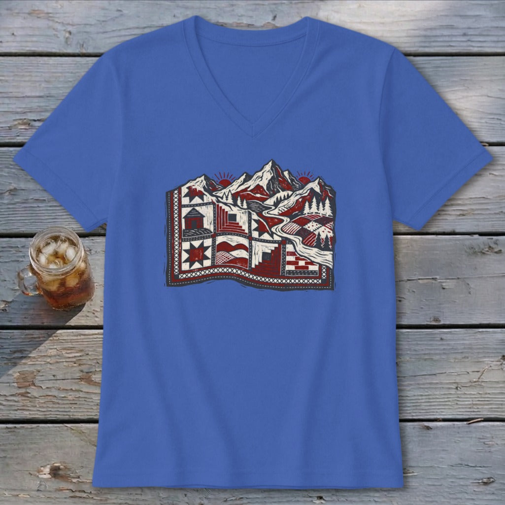 A blue V-neck t-shirt featuring a stylized graphic of a mountain quilt landscape.