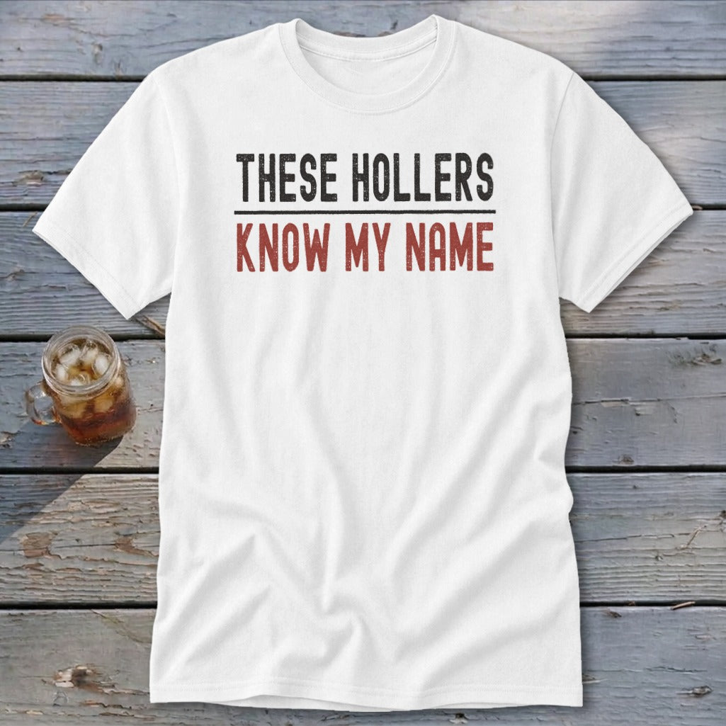 White t-shirt with black and red text that reads "THESE HOLLERS KNOW MY NAME".