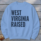 Light blue sweatshirt with "WEST VIRGINIA RAISED" in dark blue text.