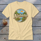 Cream t-shirt with circular graphic of Alabama landscape and deer.