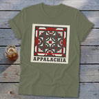An olive green t-shirt featuring a square quilt block graphic and the text Appalachia.