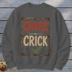 Gray sweatshirt with a distressed sign reading "CRICK" and "CREEK" crossed out.