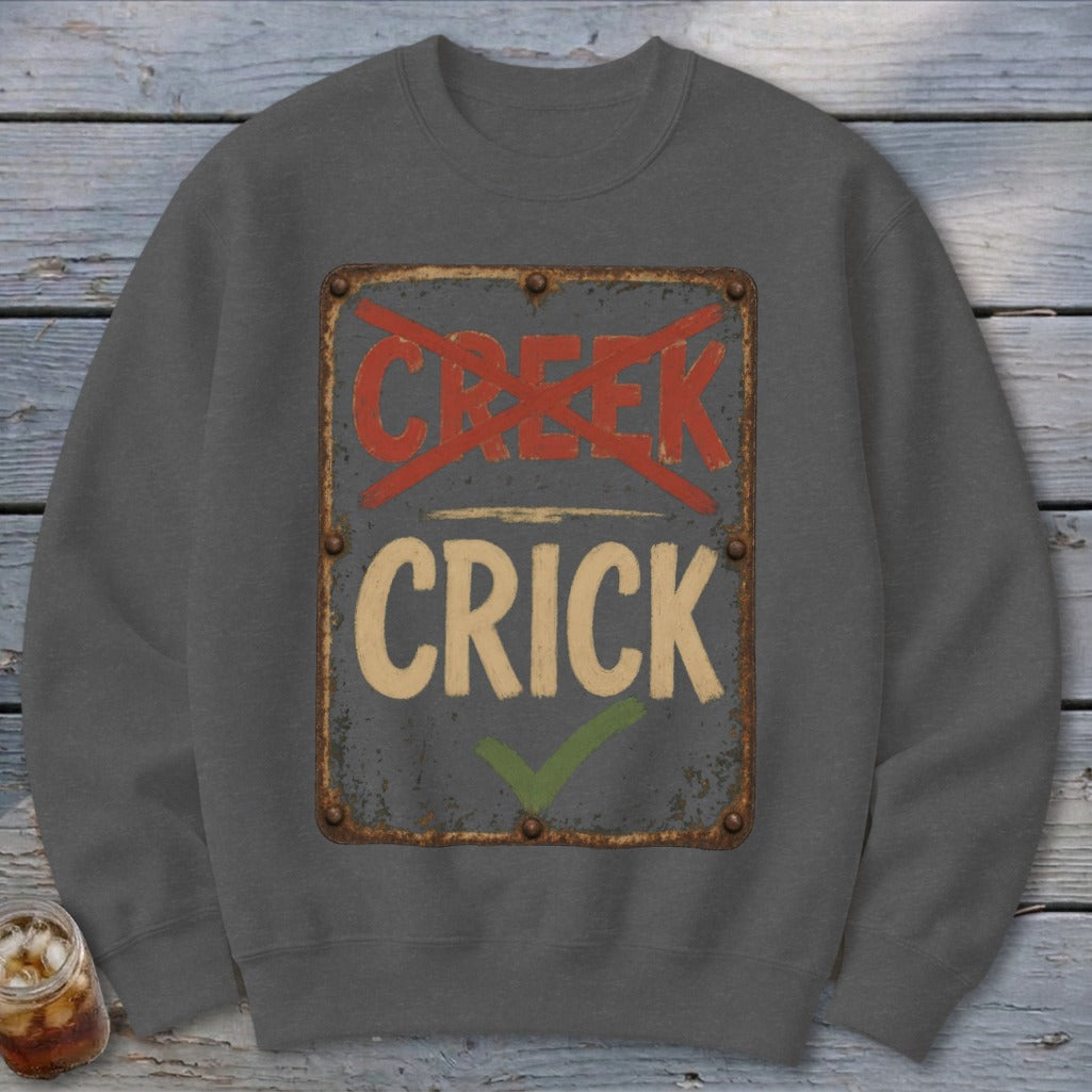 Gray sweatshirt with a distressed sign reading "CRICK" and "CREEK" crossed out.