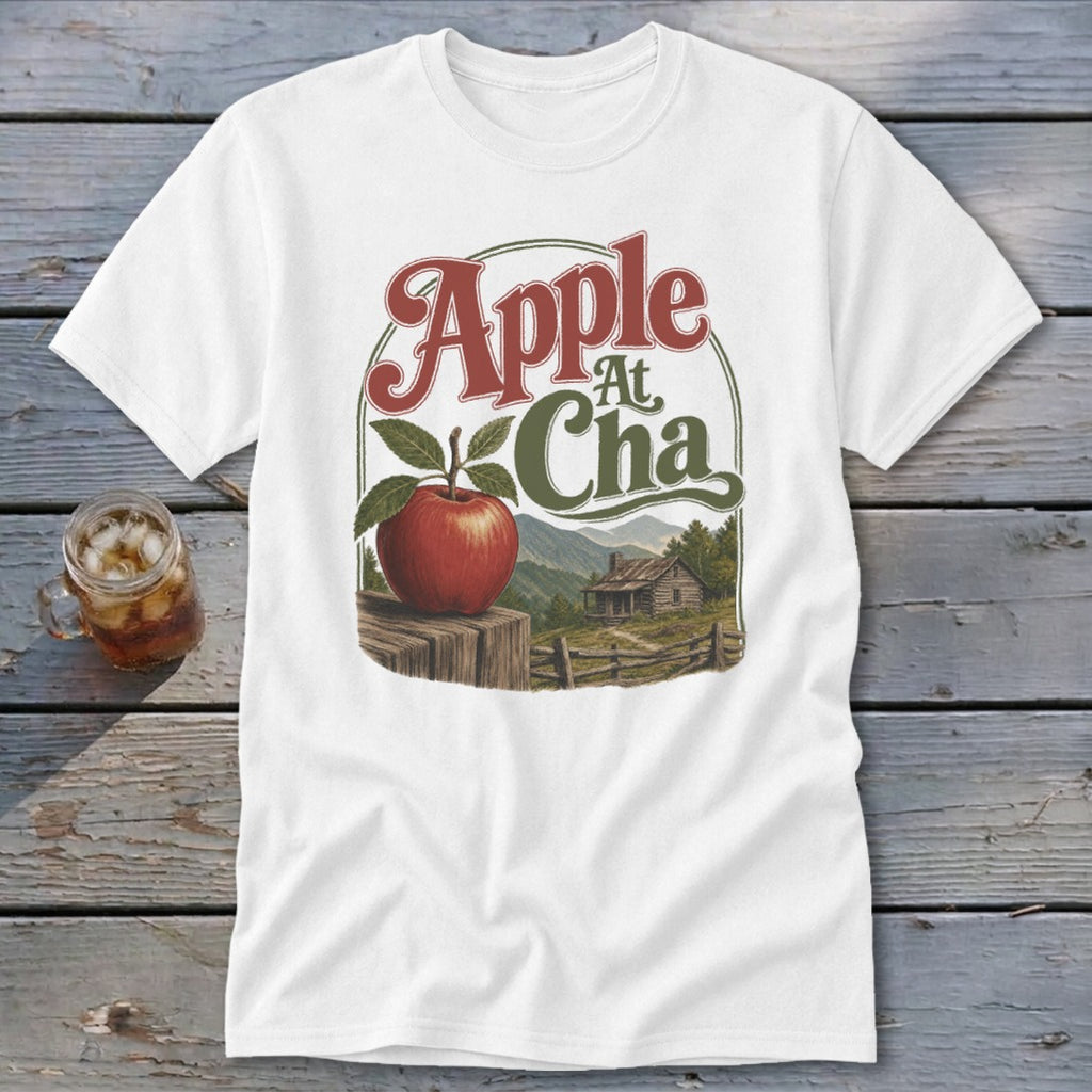 A white t-shirt featuring a retro graphic of an apple, a cabin, and the text Apple At Cha.