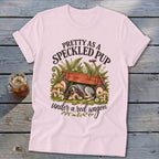 Pink t-shirt with a speckled pup sleeping under a red wagon and text.
