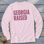 Pink long-sleeve shirt with "GEORGIA RAISED" text in maroon.