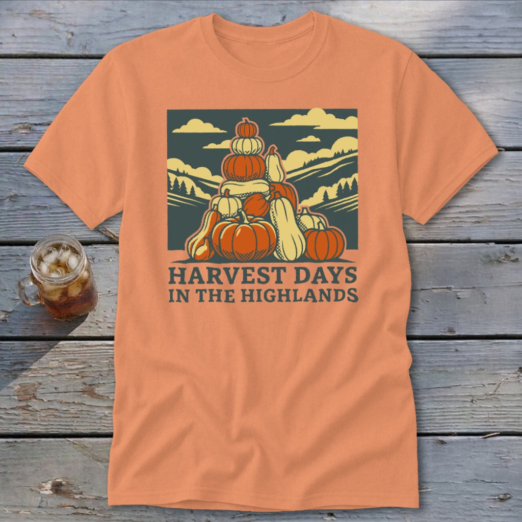 An orange t-shirt featuring a stack of pumpkins and the text "Harvest Days in the Highlands."