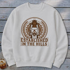 White sweatshirt with brown lantern graphic and text "ESTABLISHED IN THE HILLS".