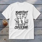 White t-shirt with "Barefoot on the Creek Bank" text and graphic.